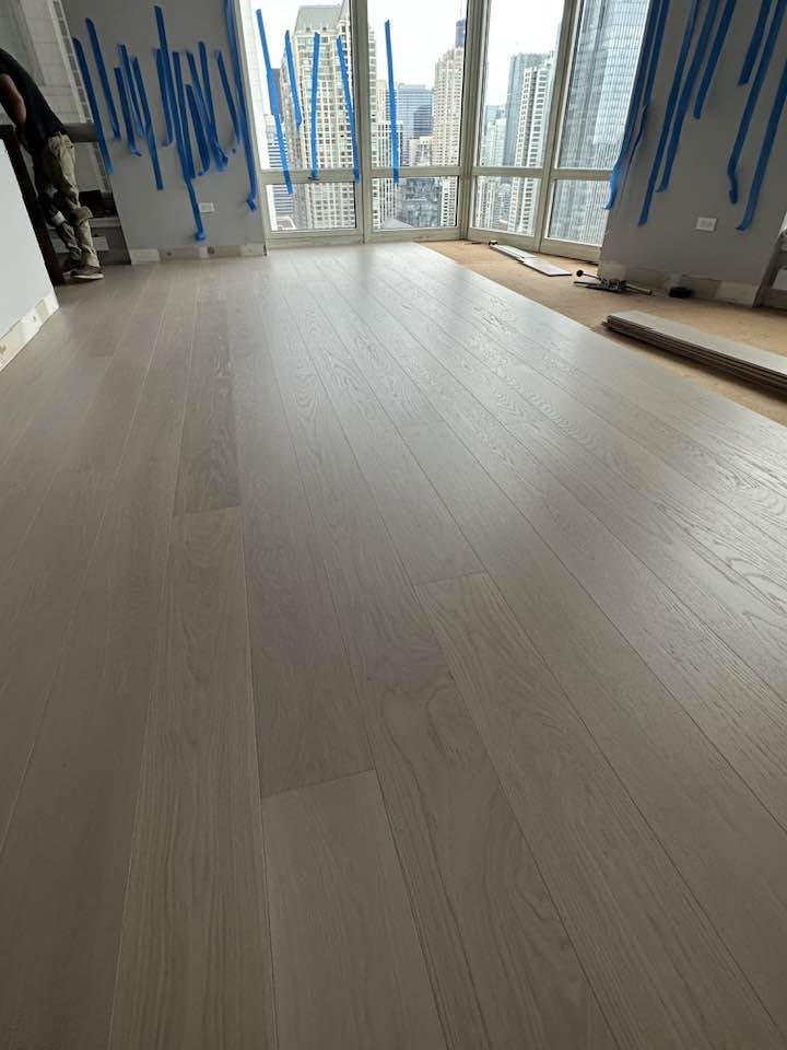 Finished wood floor at walls and interior edges