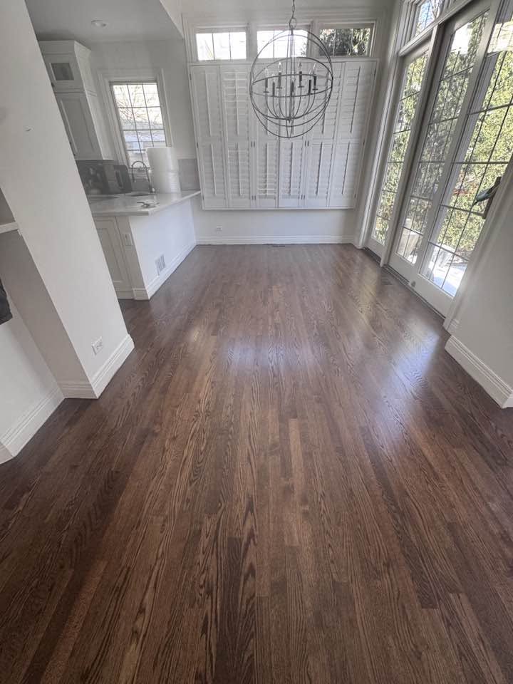 Dark stained hardwood flooring with visible natural grain in an MGM project