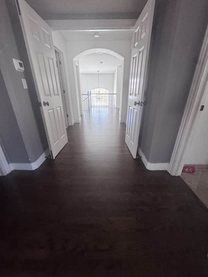 Dark wood flooring coordinated across floor and stair elements